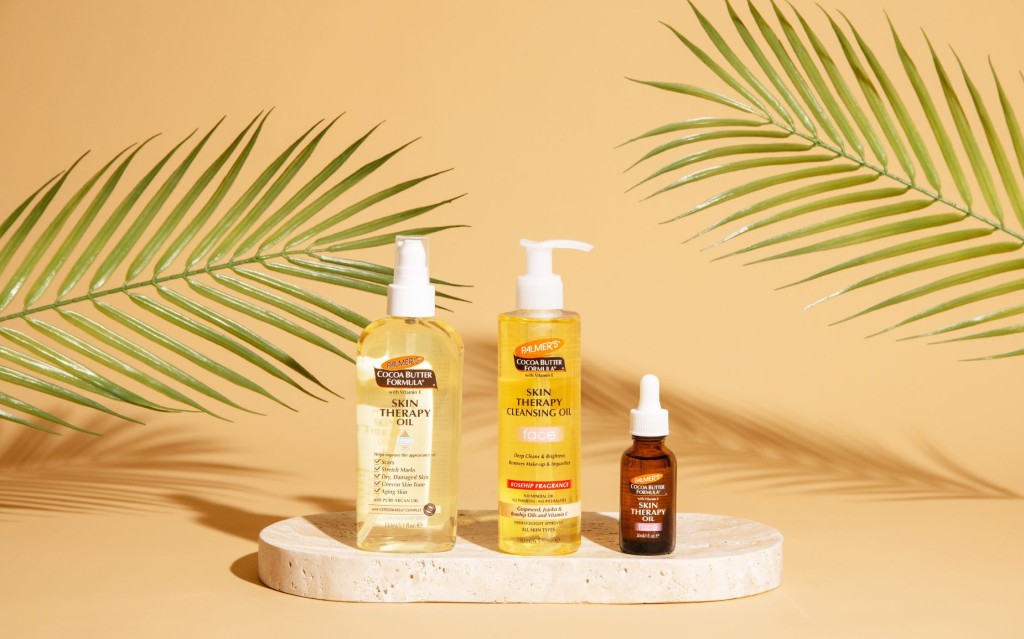 skin therapy oil for face and body and cleansing oil on tray on neutral background