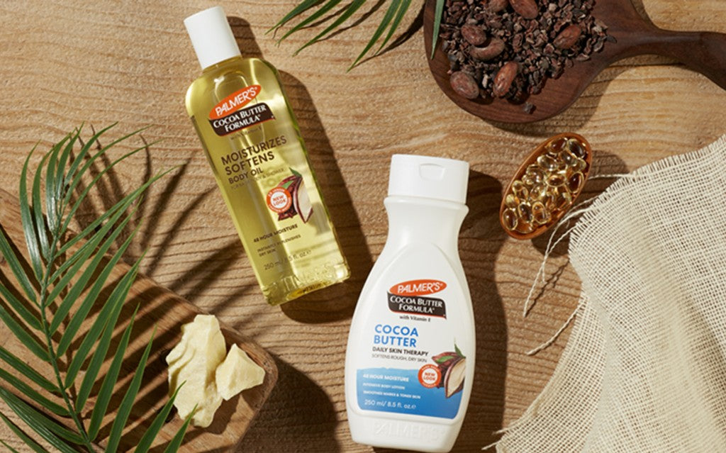 cocoa butter body lotion and body oil flatlay with cocoa butter ingredients