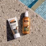 Two Palmers skincare products on a concrete surface near a pool.