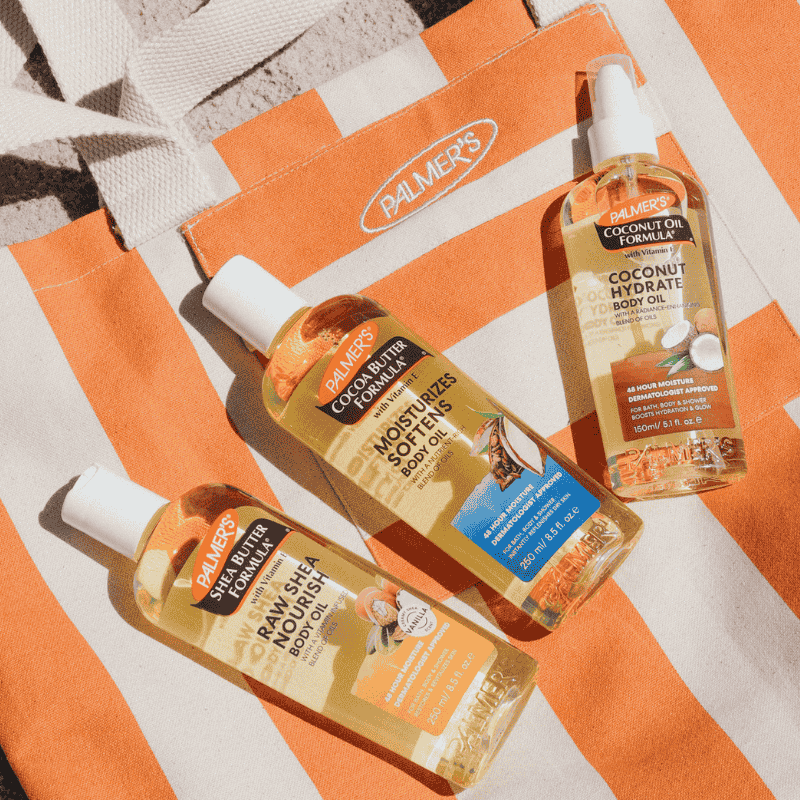 Three bottles of Palmer's body oils on an orange and white striped background with 'Palmer's' branding.