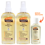 Three bottles of Palmer's Cocoa Butter Formula Skin Therapy Oil shown on a white background, with a bonus 25ml bottle indicated by an orange arrow and text.