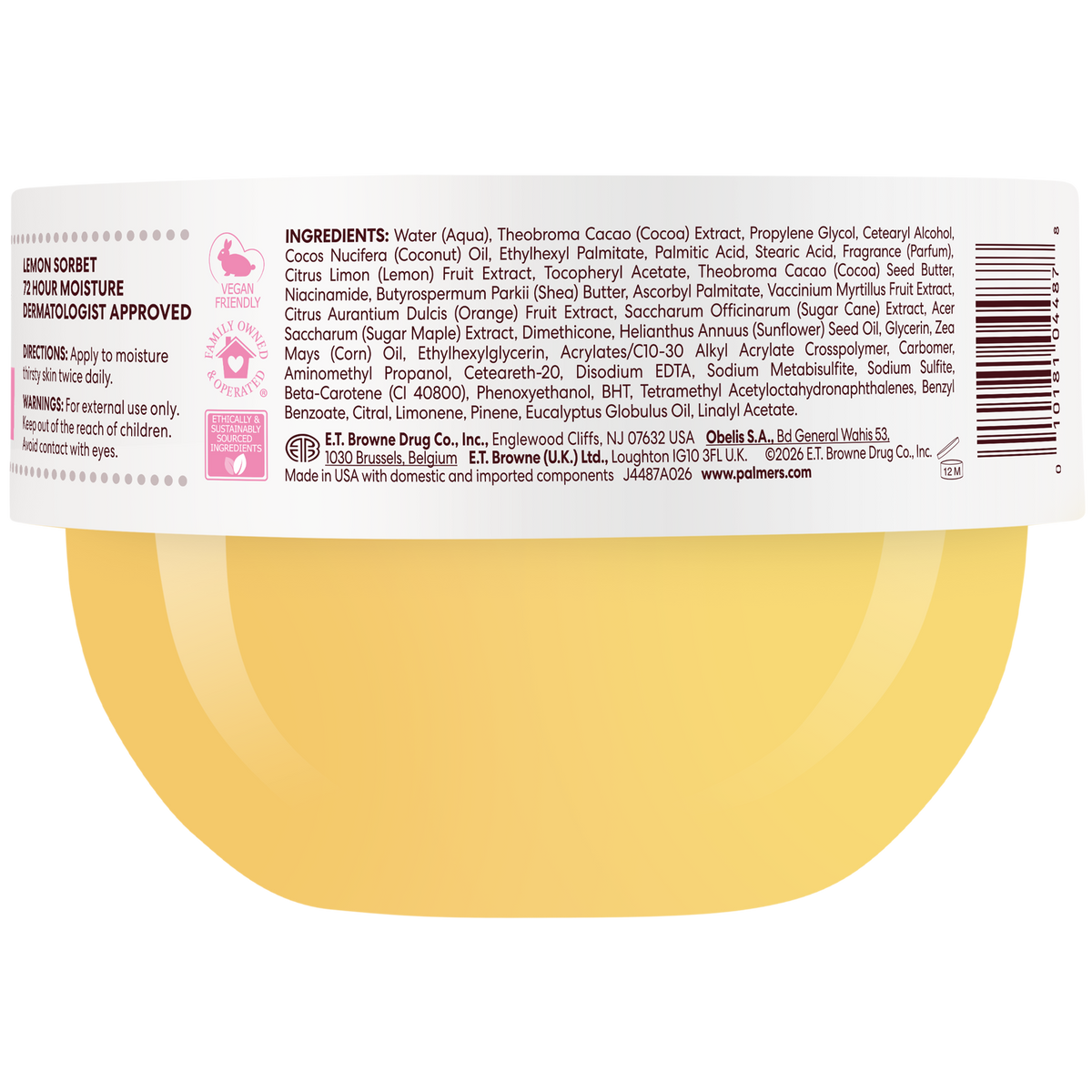 Close-up of the back of a round container showing a white label with black text, a barcode, and a yellow circular graphic at the bottom. The label includes product details such as scent notes, ingredients and directions.