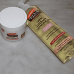 Palmer's Cocoa Butter Formula skin care products on a marble surface