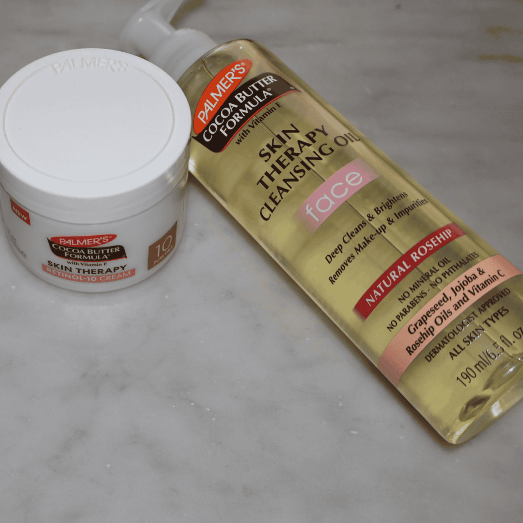 Palmer's Cocoa Butter Formula skin care products on a marble surface
