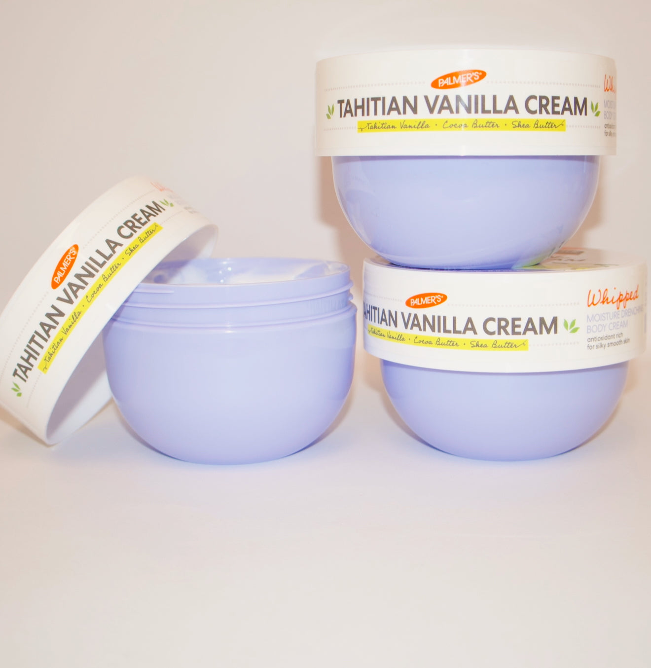 Three containers of Tahitian Vanilla Cream on a white background
