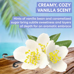 Vanilla flowers with a vanilla bean on a wooden surface, set against a blurred beach background.