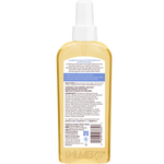 Back view of a bottle of Palmer's Cocoa Butter Formula Hair & Scalp Oil in Tahitian Vanilla, showing the detailed product instructions and ingredients on the label.