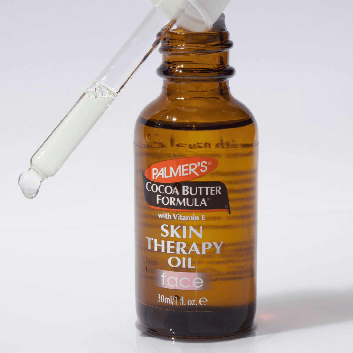 Palmer's Cocoa Butter Formula Skin Therapy Oil bottle with dropper on a white background